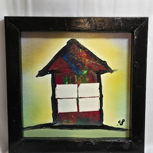 May include: Abstract painting of a house with a black frame. The house is red with white window squares and a black outline. The background is yellow and green.