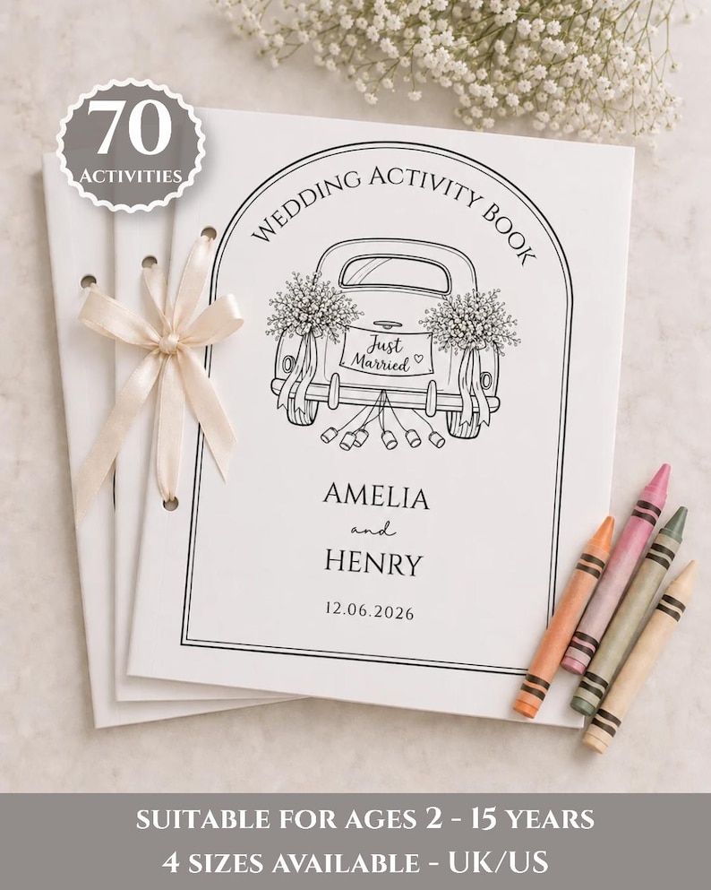 May include: A white wedding activity book with a black line drawing of a car with the text Just Married, Amelia and Henry, and 12.06.2026. The book is tied with a cream ribbon and includes four crayons in orange, pink, green, and tan colors.