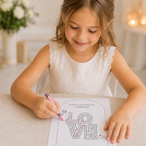 May include: A white paper activity sheet featuring a black-lined maze in the shape of the word LOVE, with the text Help the couple find their wedding rings! at the top, being colored with a pink crayon to trace a path from a couple to two rings.