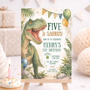 May include: A birthday invitation on a small wooden easel. The invitation features a green dinosaur illustration with the text "FIVE A-SAURUS!" and details for a 5th birthday party, including the date, time, and location.
