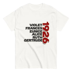 May include: White t-shirt with the names Violet, Frances, Eunice, Alice, Ruth, and Gertrude printed in black. The year "1926" is printed in red next to the names. The shirt is made of a soft material.