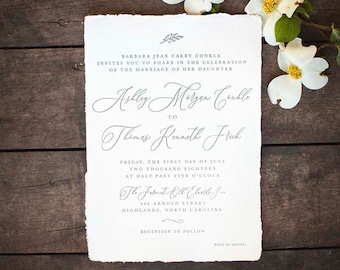 handmade paper wedding invitation with torn deckled edges and calligraphy