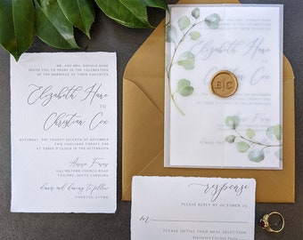 handmade paper wedding invitation with torn deckled edges and leaf decoration