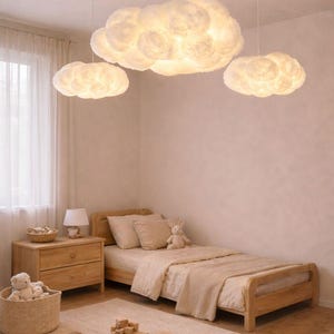 May include: A child's bedroom featuring three cloud-shaped pendant lights. The room has a wooden bed frame, nightstand, and a woven basket. A rug and toys are on the floor. The color scheme is soft and neutral.