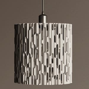 May include: A cylindrical pendant light fixture with a white, vertically slotted shade. The shade has a textured surface with numerous elongated openings. The fixture is suspended from a metal canopy and cord, creating a modern lighting design.