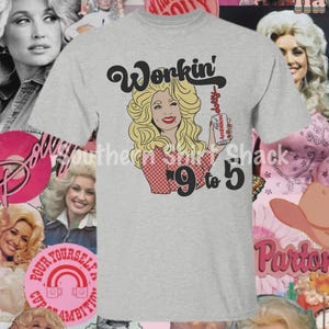 May include: A light gray short-sleeve t-shirt featuring a graphic illustration of a blonde woman with a red and white checkered top. The text reads Workin' and 9 to 5, with the woman holding a white can labeled Cup of Ambition in red lettering.