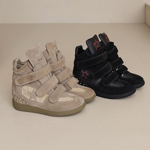 May include: Tan and black high-top sneakers with star accents. The tan sneakers have a star design on the side and silver studs on the sole. The black sneakers have a red star on the tongue. Both styles feature multiple hook-and-loop straps.