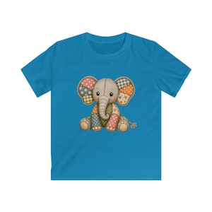 May include: A bright blue short-sleeved t-shirt featuring a central graphic of a sitting elephant. The elephant has a patchwork design with various patterns including polka dots, gingham, and floral prints in shades of brown, tan, and cream.