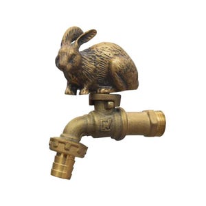 Op de afbeelding: Een messing tuinkraan met een gedetailleerde konijnsculptuur. De kraan heeft een standaard slangenaansluiting en een getextureerde afwerking. Het konijn zit met opstaande oren. Decoratief en functioneel ontwerp voor de tuin.