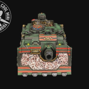 May include: A detailed miniature tank painted in shades of green, red, and orange. The model features intricate detailing, including a large cannon and decorative elements. The text "YOUR NEXT COOL MINI" is visible in a circular logo.