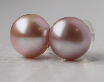 May include: A pair of pearl earrings with a soft pink hue. The pearls are round and have a smooth, glossy finish.