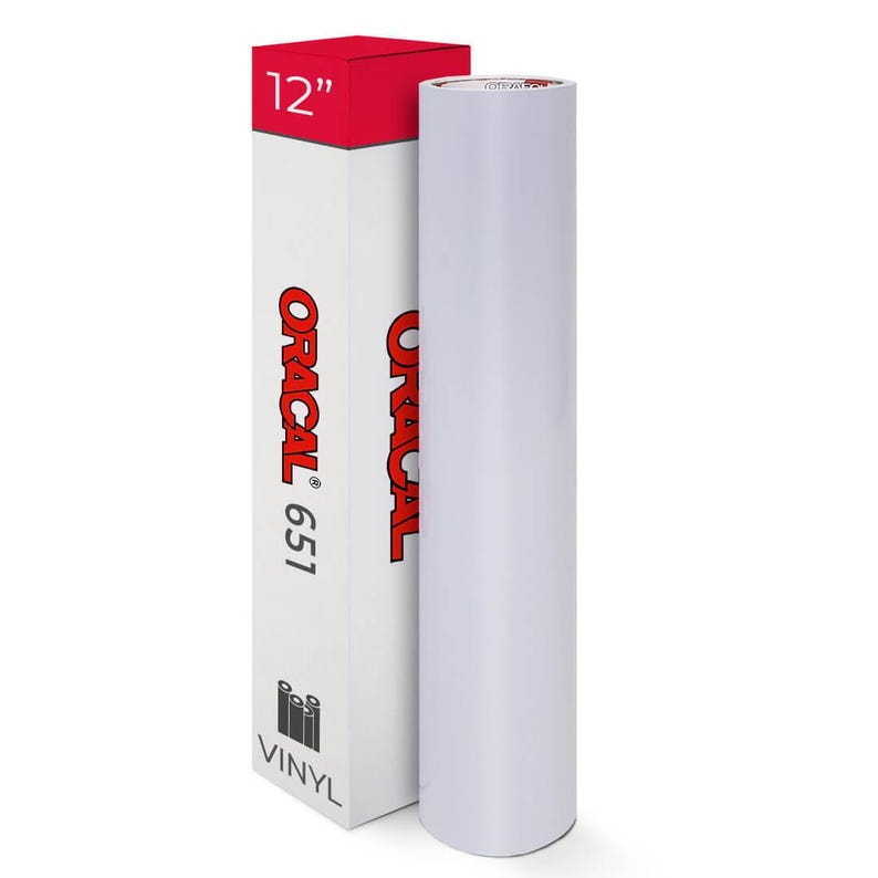 May include: A white vinyl roll next to a white box with red accents. The box is labeled "ORACAL 651" and "12" inches". The word "VINYL" is printed at the bottom of the box. The roll is approximately 30 cm wide.
