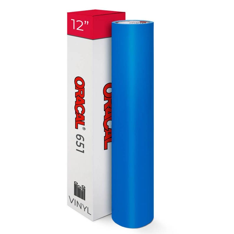 May include: A roll of bright blue vinyl next to a white box with red accents. The box is labeled "ORACAL 651" and "12" inches. The word "VINYL" is printed at the bottom of the box. The vinyl roll is approximately 30 cm in length.