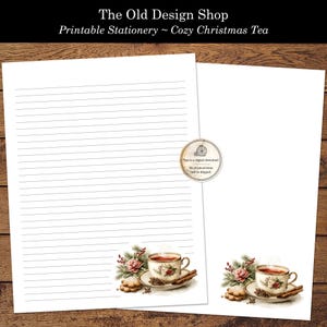 May include: Two sheets of white printable stationery with a cosy Christmas tea theme. One sheet is lined, the other is blank. Each sheet features a watercolour illustration of a teacup, cookies, and cinnamon sticks. The text "The Old Design Shop" is at the top.