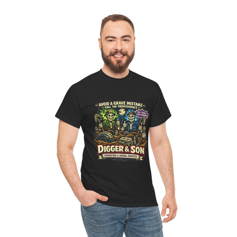 May include: Black t-shirt featuring a graphic with the text "AVOID A GRAVE MISTAKE - CALL THE PROFESSIONALS" and "DIGGER & SON CREMATION & BURIAL SERVICES". The graphic depicts skeletons with shovels. The shirt is worn by a person.