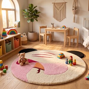 Detailed close-up view of the vibrant crimson red accent and bright orange beak on the nursery rug, proving handcrafted rugs quality.