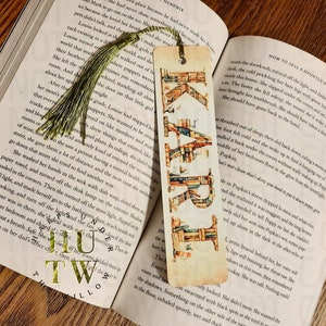 May include: A bookmark featuring the word "READ" made of stacked books. Each letter is made of a different color and style of book. The bookmark has a vintage, worn look and is perfect for book lovers.