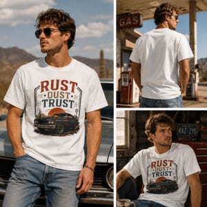 May include: A white short-sleeve t-shirt featuring a graphic print of a vintage car in a desert landscape with the text RUST DUST TRUST. The design includes a sun, a cactus, and a windmill. The shirt is shown from the front and the back.