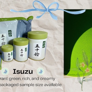 May include: Matcha tea products, including packaged tea and canisters with green lids and Japanese text labels. A bowl of matcha tea is also shown, with a vibrant green colour and floral accents. A blue ribbon is at the top of the image.