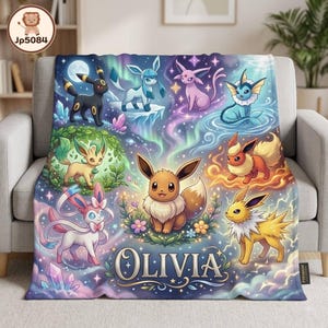 May include: A soft throw blanket featuring a colorful illustration of various Eevee evolution characters set against a starry, magical background. The name Olivia is printed in large, elegant white lettering at the bottom center of the design.