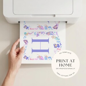 May include: A4 template being printed from a printer. The printed sheet features a large purple letter 'H' surrounded by a border of watercolour mermaids in shades of purple, blue, and pink. Text on the sheet reads 'PRINT AT HOME'.