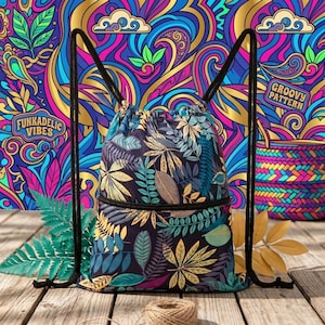 May include: A drawstring backpack featuring a dark fabric base with a repeating pattern of various leaves in shades of yellow, teal, and purple. The bag has black cord straps and a horizontal zippered pocket across the front section of the bag.