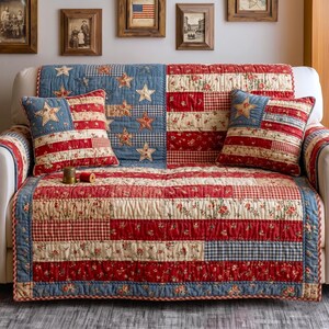 May include: A sofa adorned with a patriotic quilt and matching throw pillows. The quilt and pillows feature a patchwork design in red, white, and blue, with star and stripe patterns reminiscent of the American flag. The quilt measures approximately 70 inches wide.