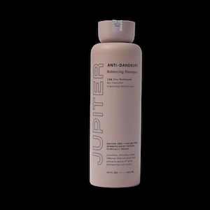 May include: A light pink bottle of JUPITER Anti-Dandruff Balancing Shampoo. The bottle has a cylindrical shape with a rounded top and a smaller cap. Text on the bottle includes product information and states it contains 415 ml.
