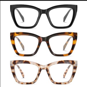 May include: Three pairs of eyeglasses with thick, cat-eye frames. The top pair is black, the middle pair has a tortoiseshell pattern, and the bottom pair is a light tortoiseshell pattern. All have clear lenses.