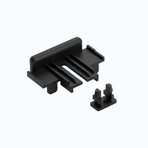 Pode incluir: Componente de plástico preto com uma base retangular e múltiplas ranhuras e protuberâncias. Uma peça separada menor com dois postes verticais também está presente. As peças são projetadas para se encaixarem.