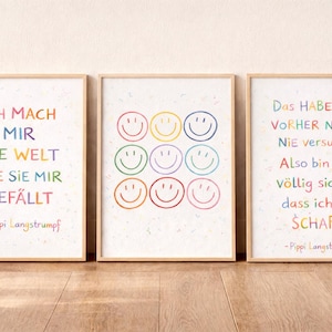 Könnte beinhalten: Drei gerahmte Kunstdrucke mit deutschen Zitaten und Smiley-Designs. Die Drucke haben hellbraune Rahmen und weiße Hintergründe. Der Text ist in verschiedenen Farben gehalten. Die Zitate werden Pippi Langstrumpf zugeschrieben.