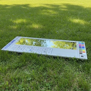 May include: A rectangular mirror designed to resemble the classic Microsoft Paint interface, with a reflective surface and a white frame. The mirror includes a toolbar with icons and a color palette on the right side. The text "Untitled Paint" is visible.