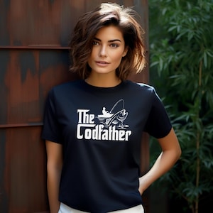 May include: Black t-shirt with the white text "The Codfather" and a graphic of a fisherman and a fish. The shirt is short-sleeved and made of a soft material.