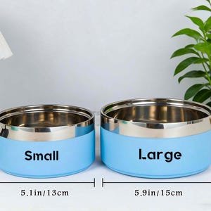 May include: A white ceramic mug with a black handle and the text "But First, Coffee" in a bold, black font. The mug is set against a blurred background, suggesting a cozy setting. The mug appears to be approximately 4 inches tall.