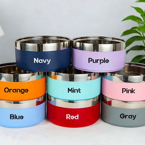 May include: A set of three ceramic mugs with a speckled, matte finish. Each mug features a different color: light blue, cream, and gray. The mugs have a simple, modern design, perfect for coffee or tea.