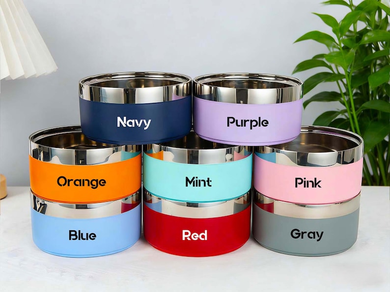 May include: A set of three ceramic mugs with a speckled, matte finish. Each mug features a different color: light blue, cream, and gray. The mugs have a simple, modern design, perfect for coffee or tea.