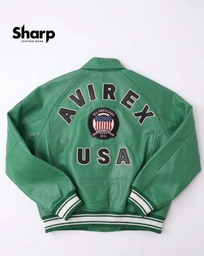 May include: Green leather jacket with the word "AVIREX" across the back in white lettering. The jacket features a patch with the words "ALL AMERICANS" and "USA". The jacket has white and black striped cuffs and hem.