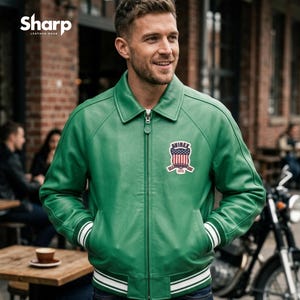 May include: Green leather jacket with a white and green striped trim on the cuffs and hem. The jacket has a zipper closure and a patch on the chest with the text "AVIREX" and an American flag design. The brand "SHARP LEATHER WEAR" is in the top left corner.
