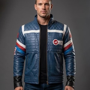 May include: A blue leather jacket featuring a quilted shoulder design, a stand-up collar, and a front zipper. The jacket includes white and red horizontal stripes on the chest and sleeves, black cuffs, and a circular patch with the text Dead Fegotes.
