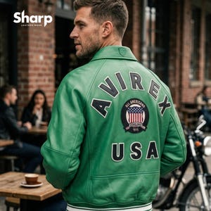 May include: A green leather jacket with the word "AVIREX" across the back, along with a patch featuring the American flag and the word "USA". The jacket has a white and blue striped hem and cuffs.