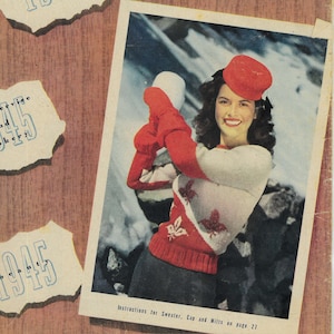 May include: A vintage magazine cover from January 1945 featuring the title "EVERYWOMAN" in bold, black letters. The cover features a woman in a red sweater and hat, holding a snowball, against a snowy background. The cover also includes several torn pieces of paper with the year "1945" and various words like "fashion", "homeservice", "cookery", and "beauty" printed on them.