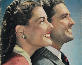 May include: A vintage magazine cover featuring a couple looking at each other with smiles. The magazine is titled "EVERYWOMAN" and the text "WHEN HE COMES HOME AGAIN" is at the bottom of the cover. The magazine cover is blue and the couple is dressed in formal attire.