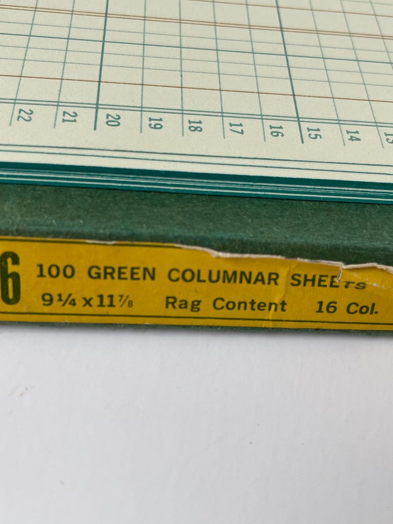 May include: A close-up of a green columnar sheet pad with a yellow label. The label reads "100 GREEN COLUMNAR SHEETS" and lists dimensions of 9 1/4 x 11 7/8 inches. The pad has a grid pattern and numbered columns.