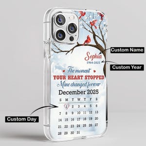 May include: Clear phone case with a personalized design. The case features a calendar with the date December 2025, a name, and the text "The moment YOUR HEART STOPPED Mine changed forever." Red cardinals perch on a tree branch.