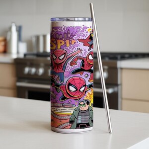 May include: A stainless steel tumbler with a comic book design, showcasing Spider-Man in red, blue, and black on a purple backdrop. The tumbler has a silver straw and the text "Spider-Man".