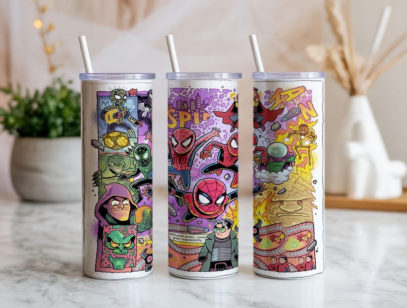 May include: Three white insulated tumblers with comic book-style illustrations of Spider-Man and villains. Each tumbler has a white straw. The designs feature vibrant colours and the words "SPIDER-MAN".