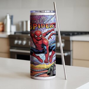 May include: A cylindrical stainless steel tumbler featuring a vibrant comic book graphic of Spider-Man in a red and blue suit, with the text SPIDER visible at the top. The tumbler includes a clear lid and a long, slender silver metal straw.