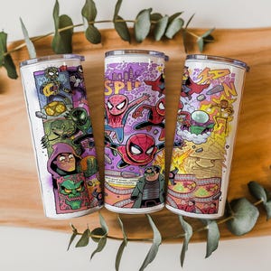 May include: Three stainless steel tumblers with vibrant comic book illustrations. The designs showcase Spider-Man and villains in action. The tumblers have white backgrounds and silver lids, ideal for drinks.