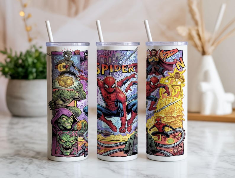 May include: Three cylindrical tumblers with white lids and straws, featuring a colorful comic book graphic print of Spider-Man and various villains. The design includes characters like Green Goblin, Doctor Octopus, and Doctor Strange in action.