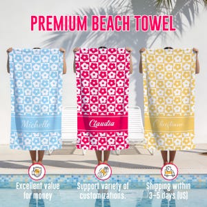 May include: Three personalized beach towels with floral patterns. One is light blue with white flowers and "Michelle" in a blue banner. Another is red with white flowers and "Claudia" in a red banner. The third is yellow with white flowers and "Christiane" in a yellow banner.